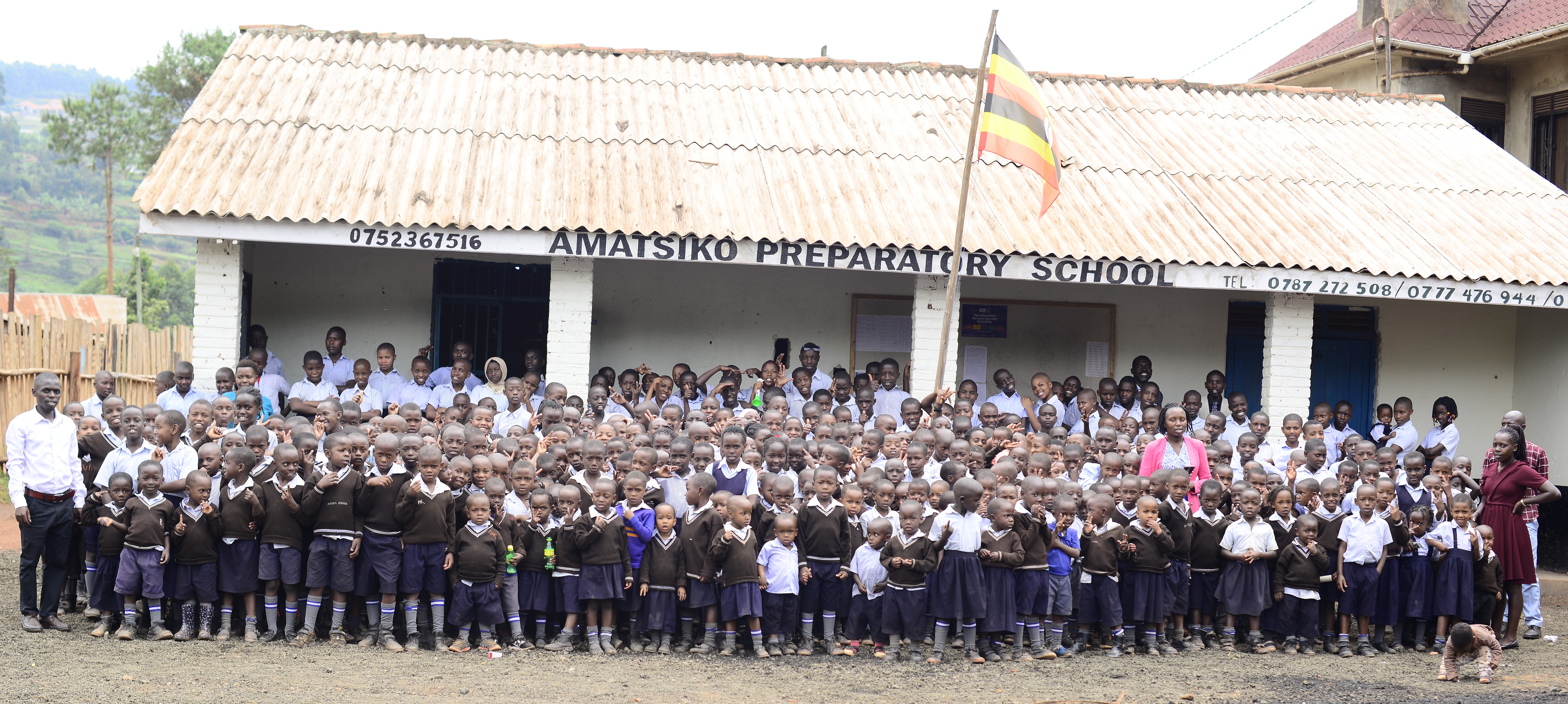Amatsiko Preparatory School pupils and teachers in front of the school posing for a photo
