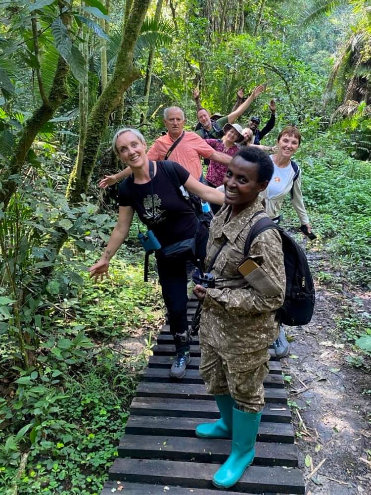 Guests enjoying a guided nature walk through Bigodi Wetland Sanctuary, exploring Uganda's rich biodiversity, tropical forest, birds, and primates.