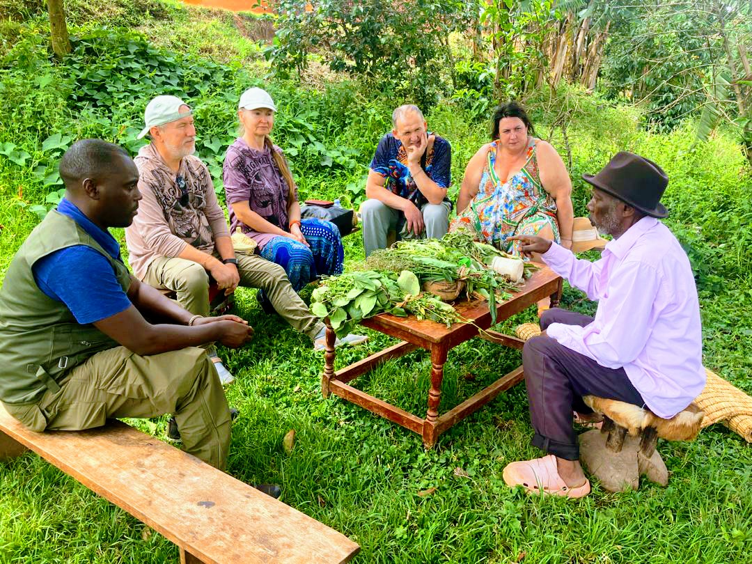 A group of guest seated with a herbalist sharing with them