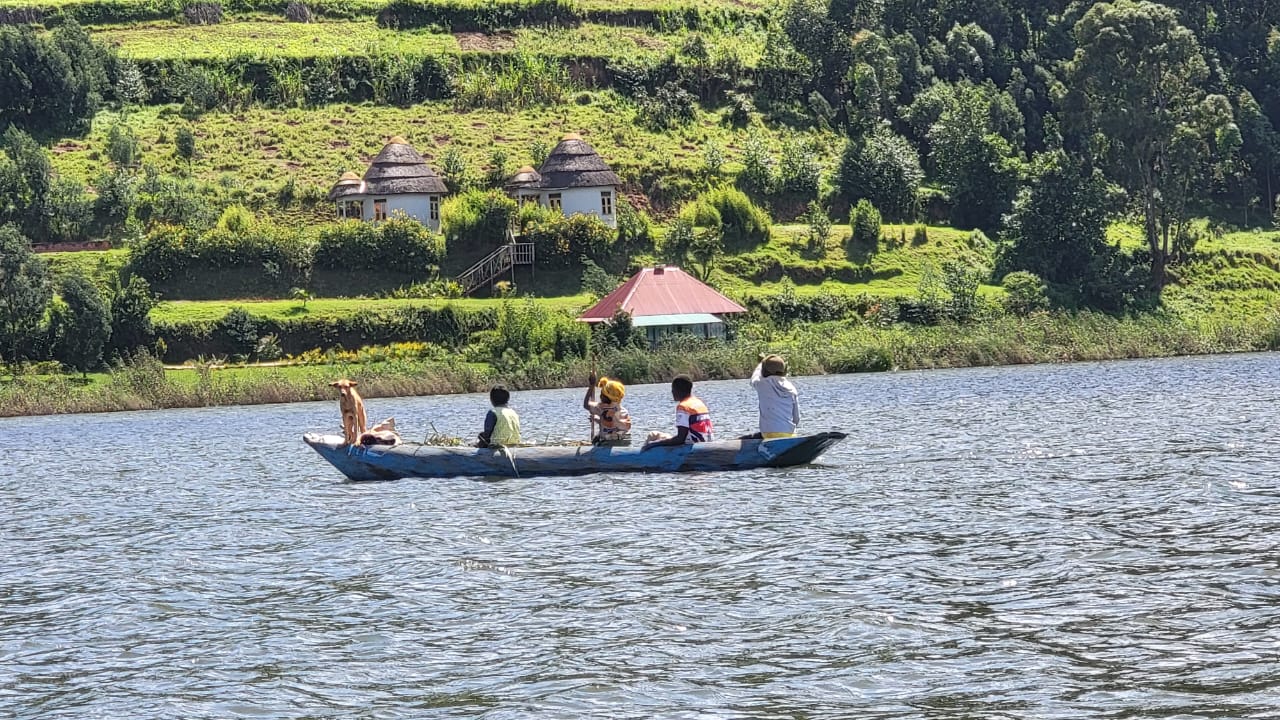 Four people in a car and a dog standing in the canoe as well