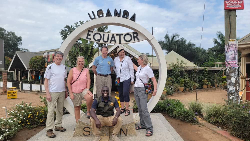 Group of travelers visiting the Uganda Equator during a budget-friendly safari package in Uganda