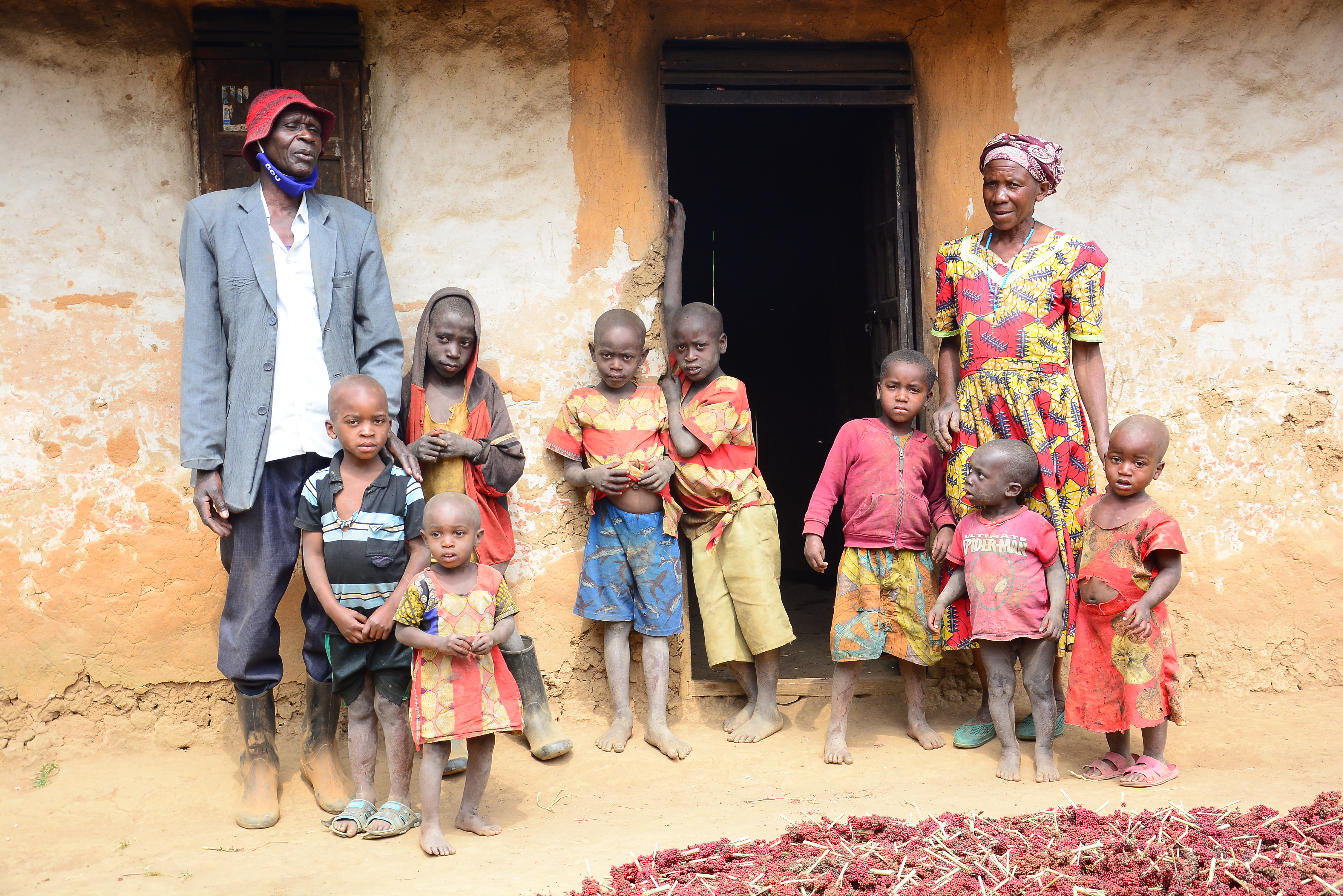 A mother and her children stand in a doorway in rural southwestern Uganda, the kind of community directly supported by responsible safari bookings