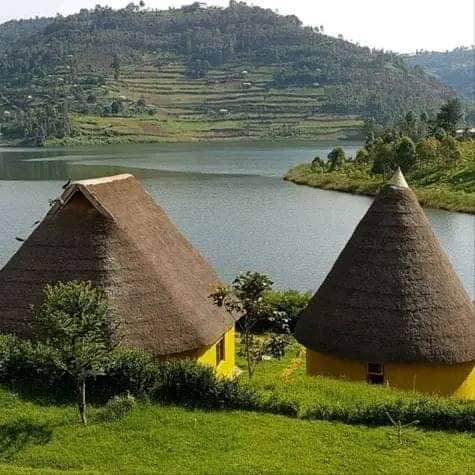 Thatched-roof lakeside huts, a reminder that rest days matter on a trekking itinerary
